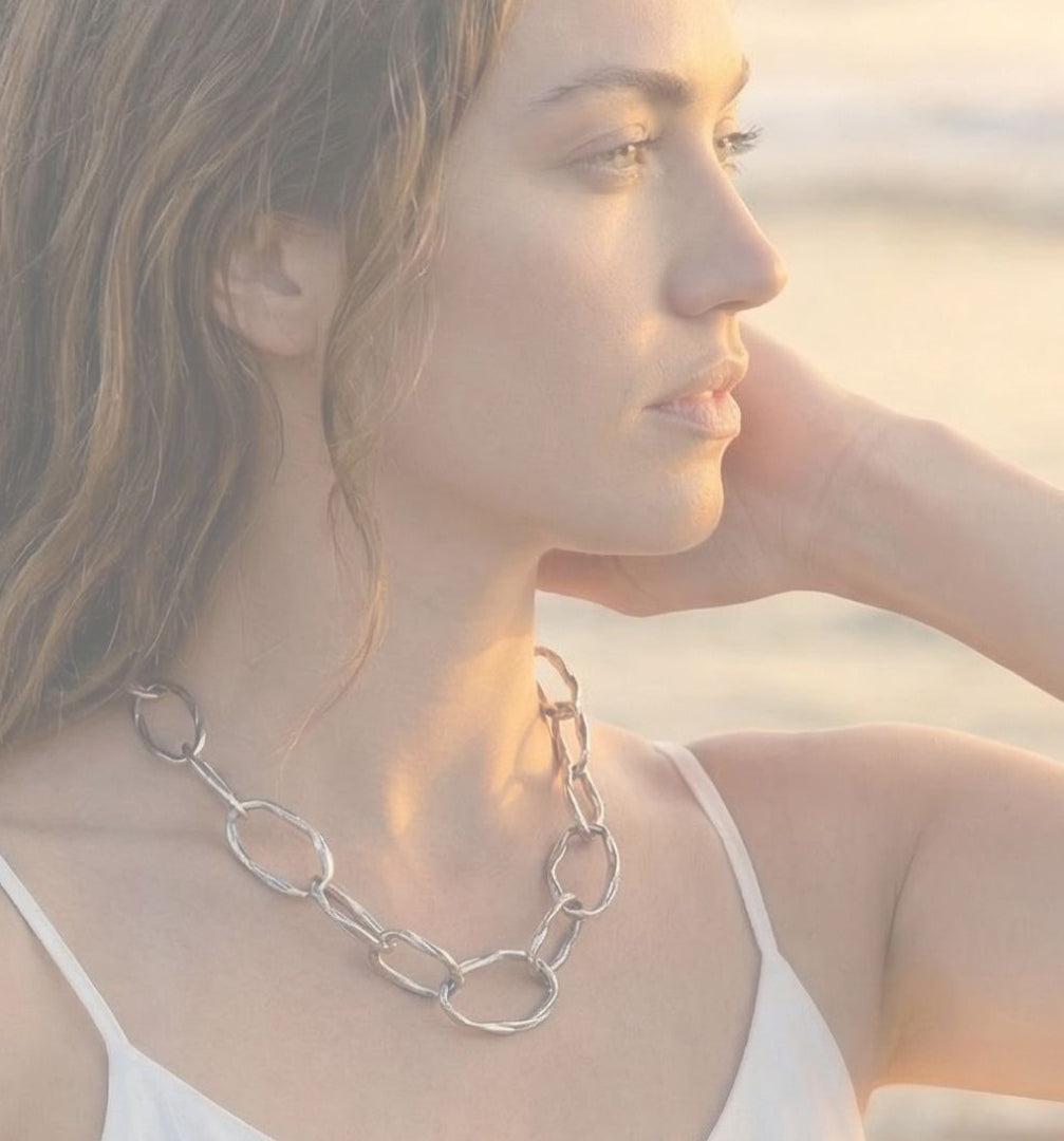 a woman on the beach wearing a pebble chain in sterling silver by michelle hoting using mitsuro hikime