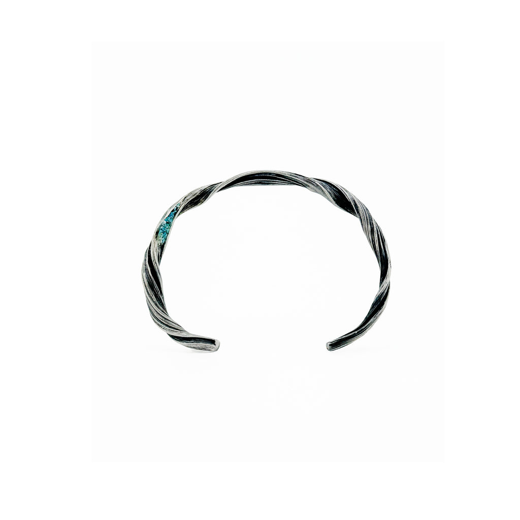 a sterling silver twisting sculptural cuff bracelet that  is inlaid with turquoise to resemble the blue sky peaking thru openings in the red rock slot canyons of Antelope Canyon by jewelry artist michelle hoting