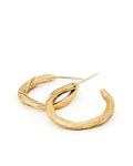a pair of 14k gold hoop earrings that have a graceful twisting pattern created to resemble pahoehoe lava by jewelry sculptor michelle hoting using mitsuro hikime