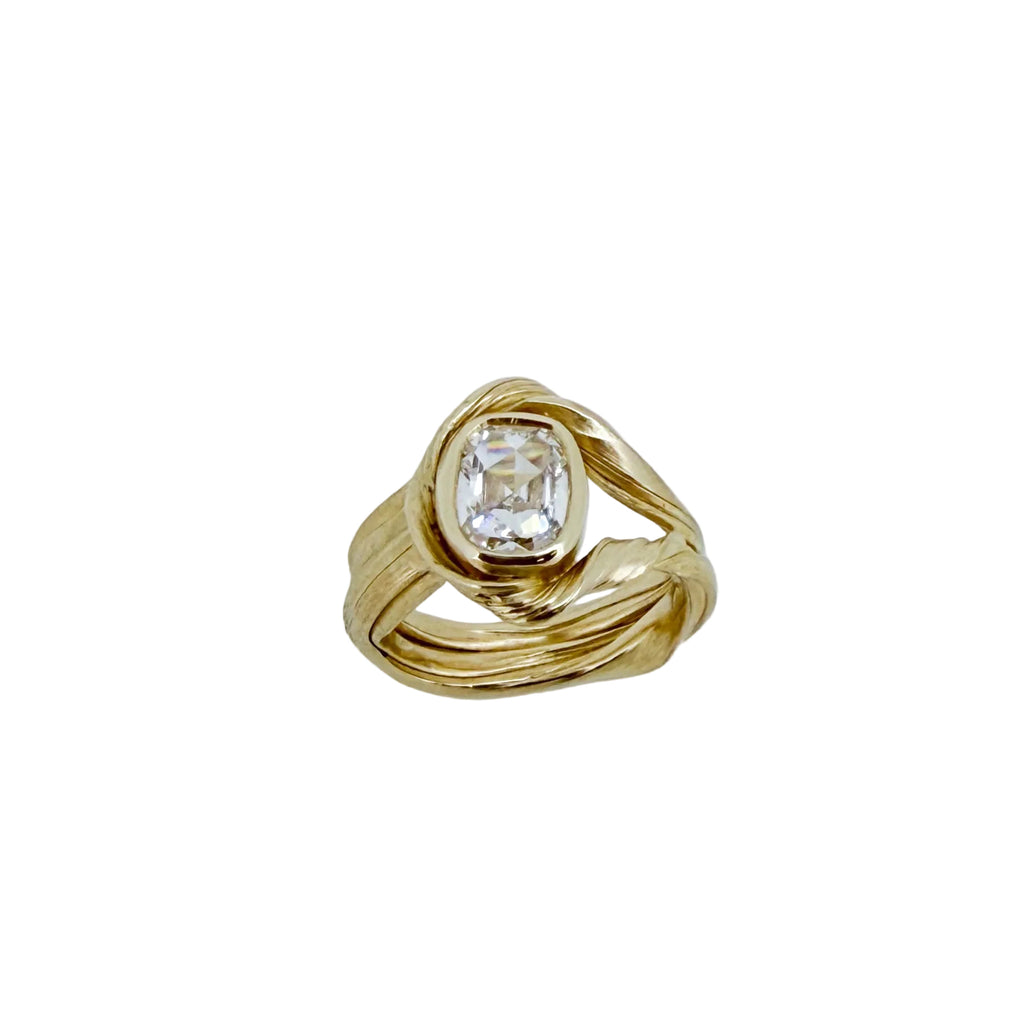 Gold ring with a diamond on a white background