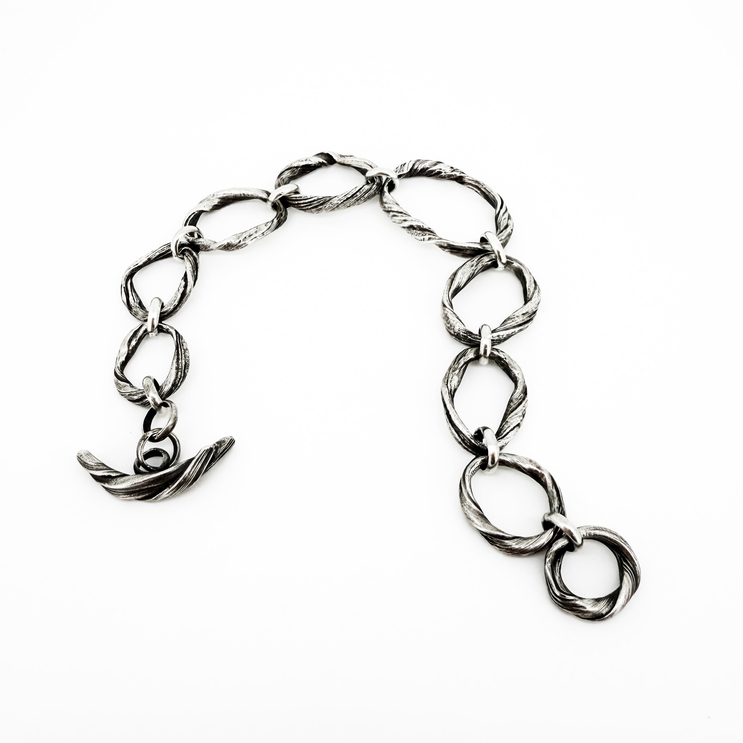 a sterling silver bracelet created to resemble beach pebbles by jewelry artist Michelle Hoting using the Mitsuro Hikime technique