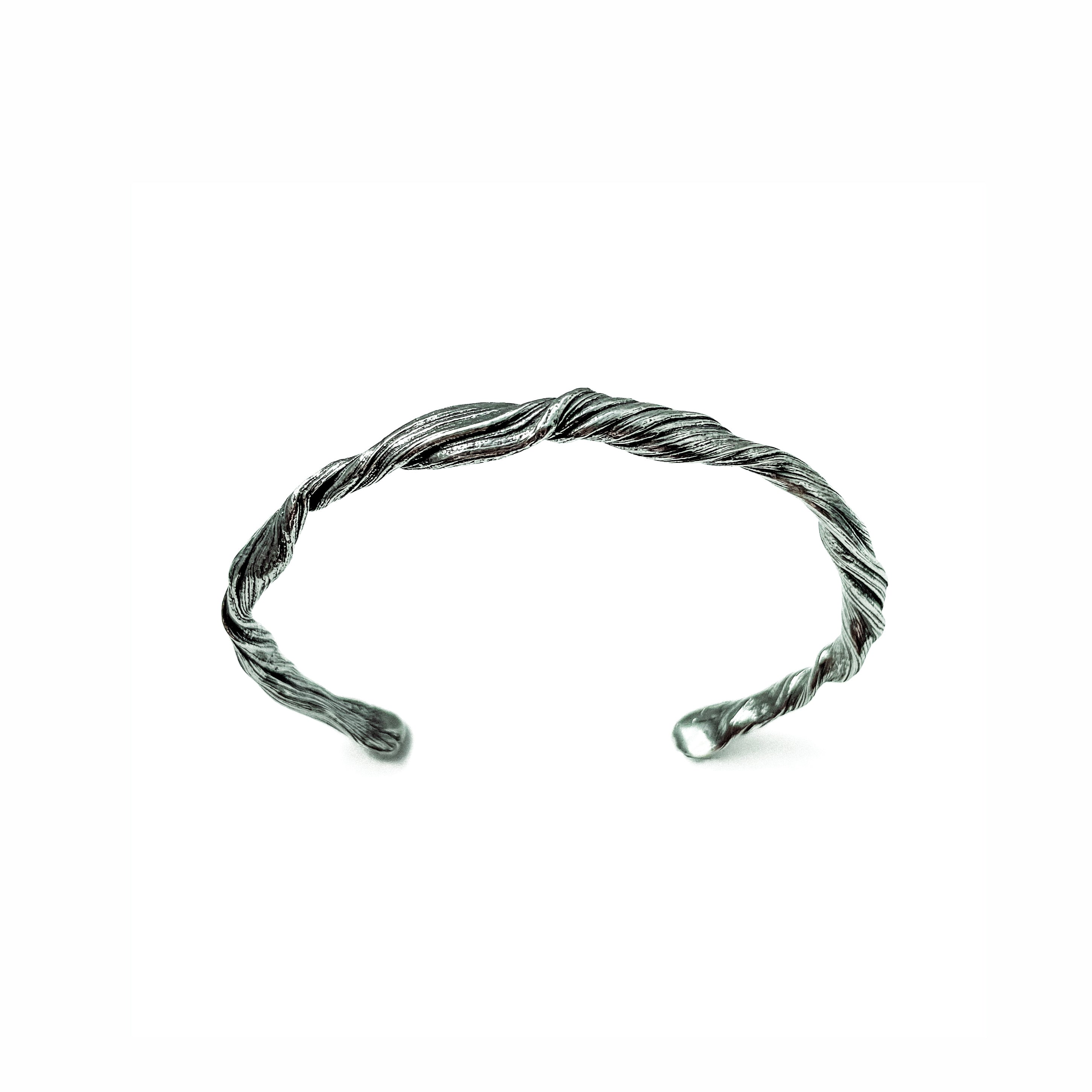 a cuff bracelet created to resemble pahoehoe lava by michelle hoting, using mitsuro hikime wax