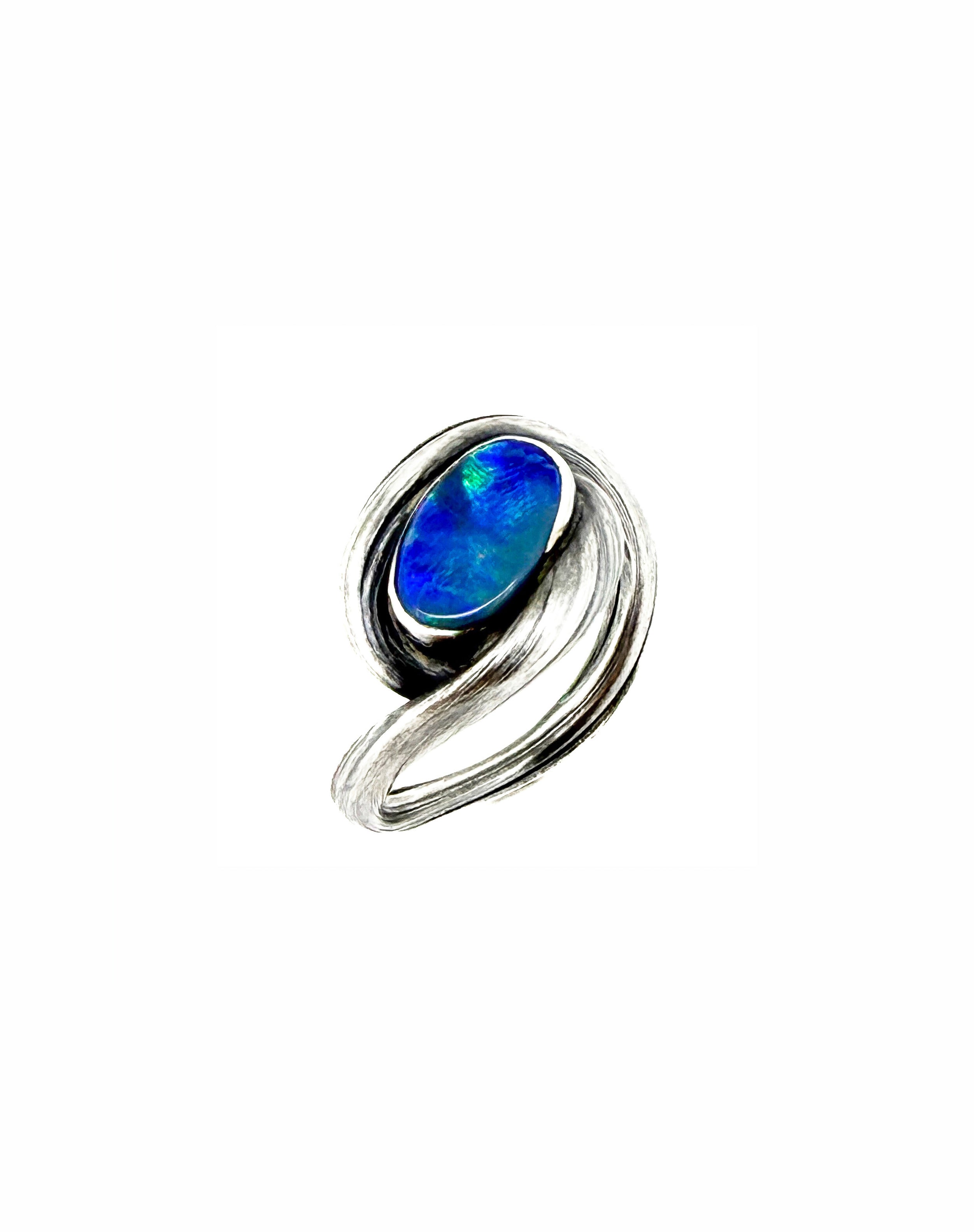 a sterling silver sculptural ring with swirling textural elements around an opal by michelle hoting