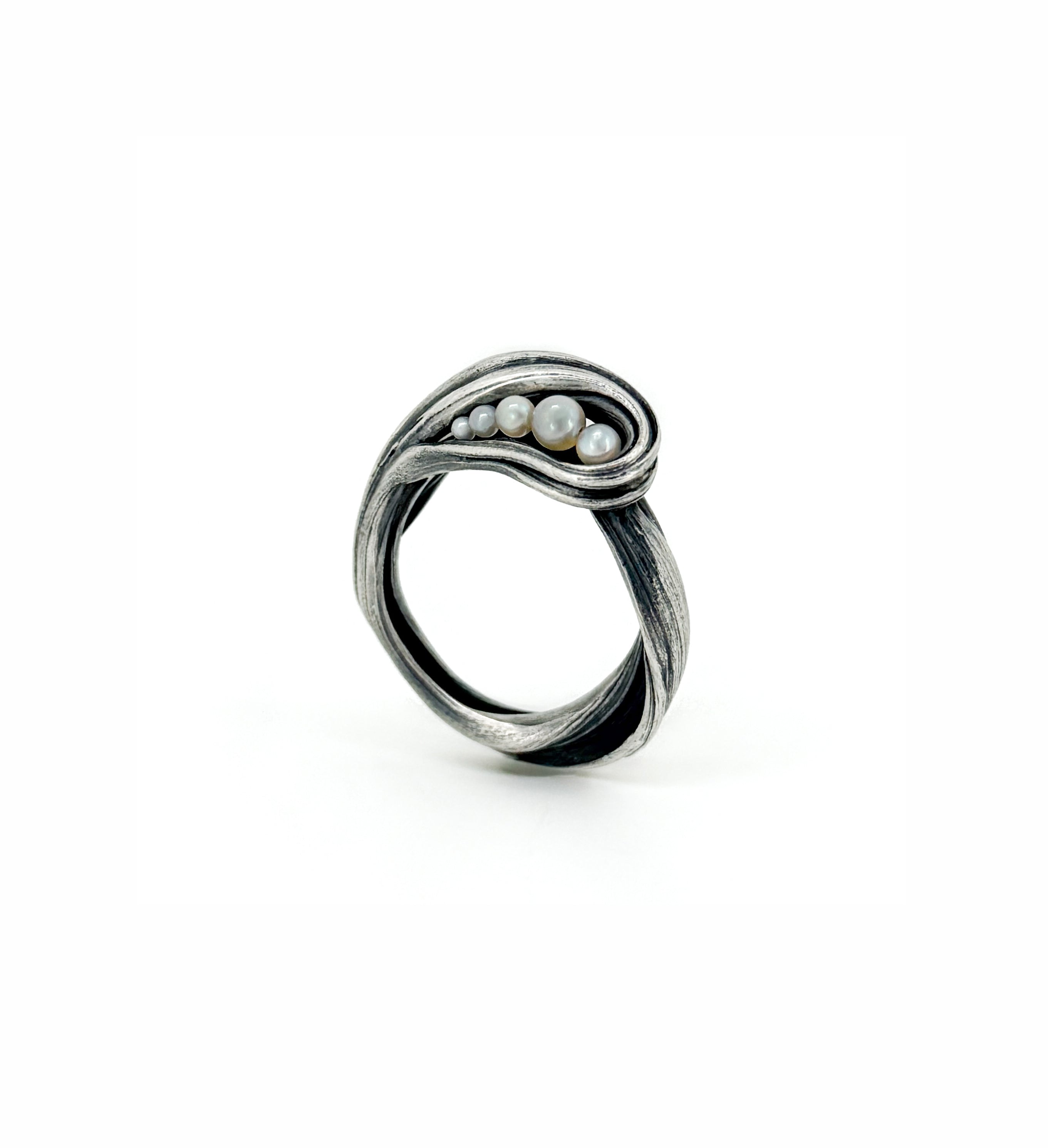 a sterling silver and akoya pearl ring created to resemble sea foam at the edge of a crashing wave by jewelry artist Michelle Hoting using the Mitsuro Hikime technique