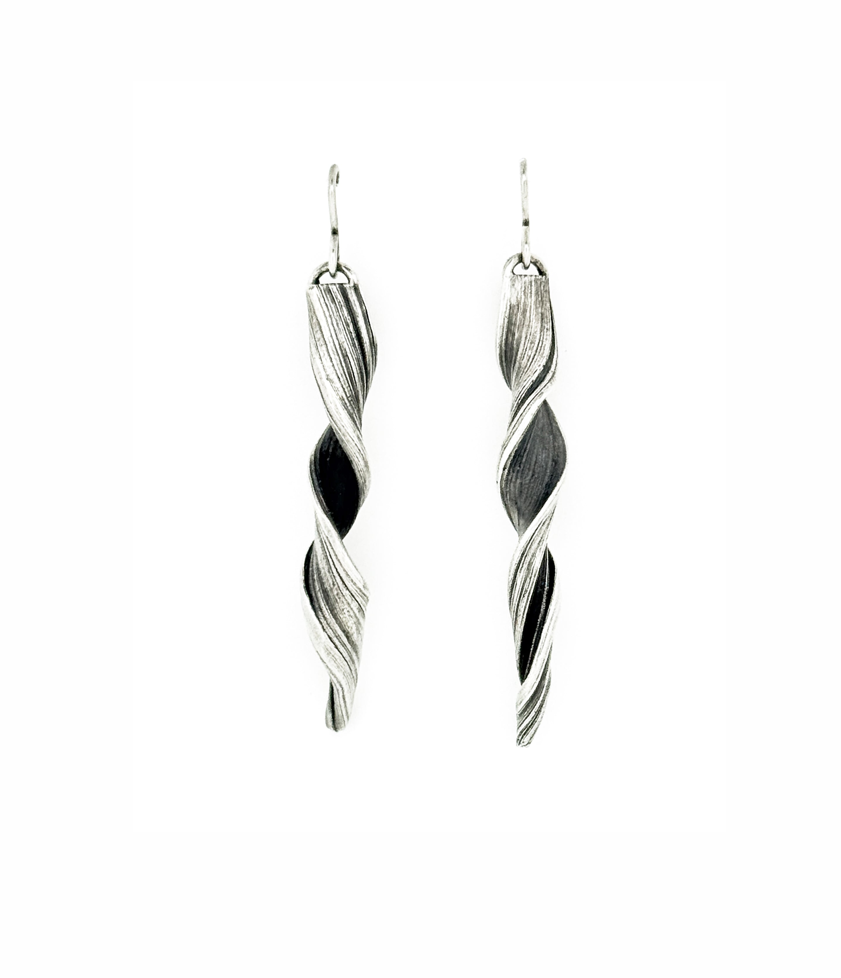 sterling silver earrings with a sculptural twist  pattern hand fabricated by jewelry artist Michelle Hoting using the Mitsuro Hikime technique