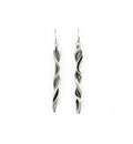 a pair of sterling silver earrings that resemble waves folding and forming.