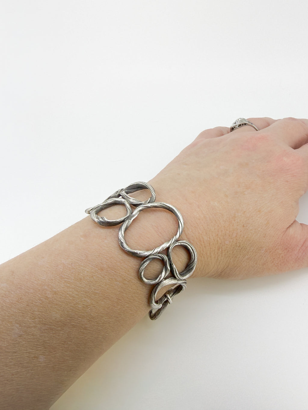 a bracelet resembling beach pebbles on a wrist
