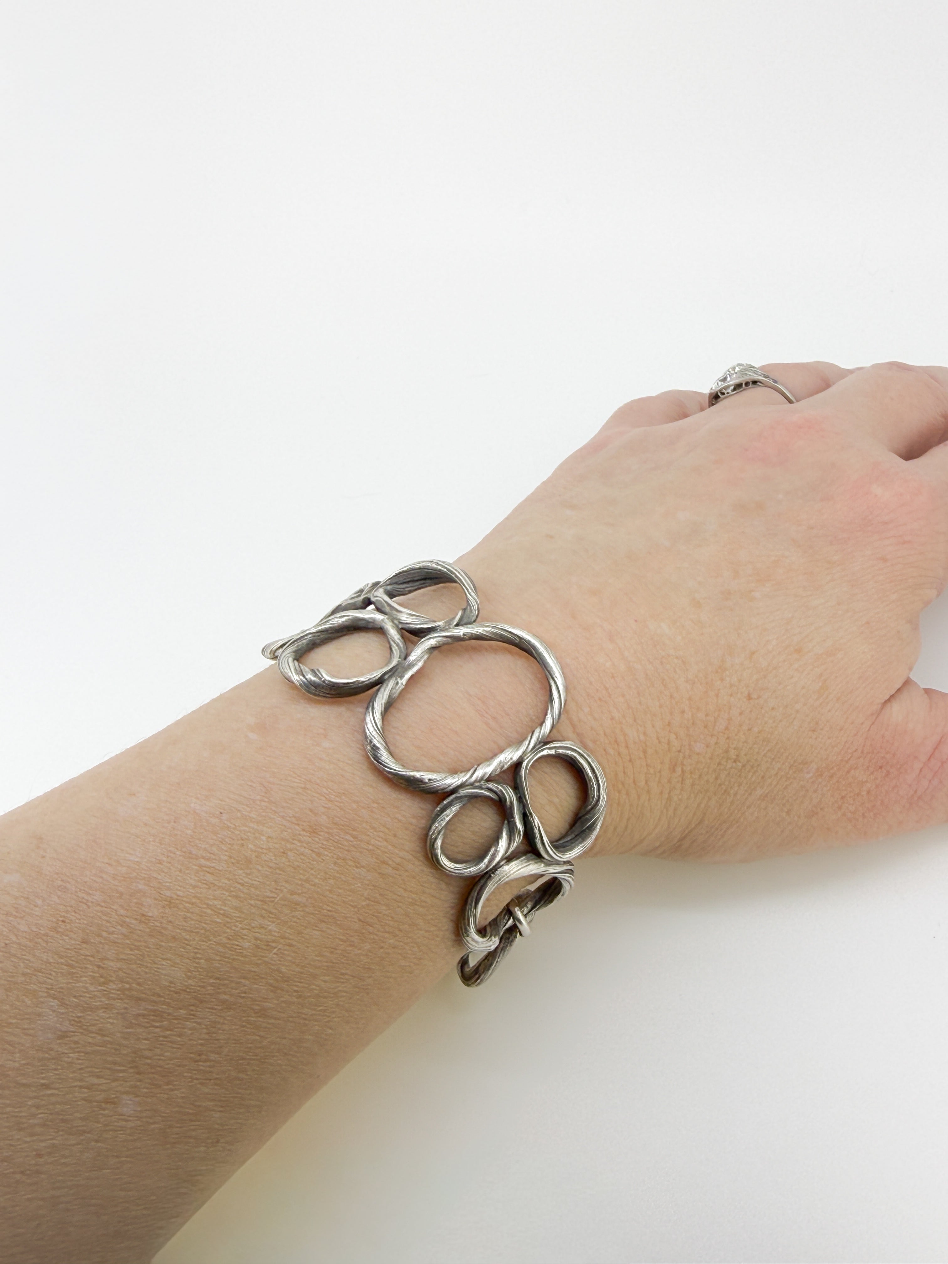 a bracelet resembling beach pebbles on a wrist