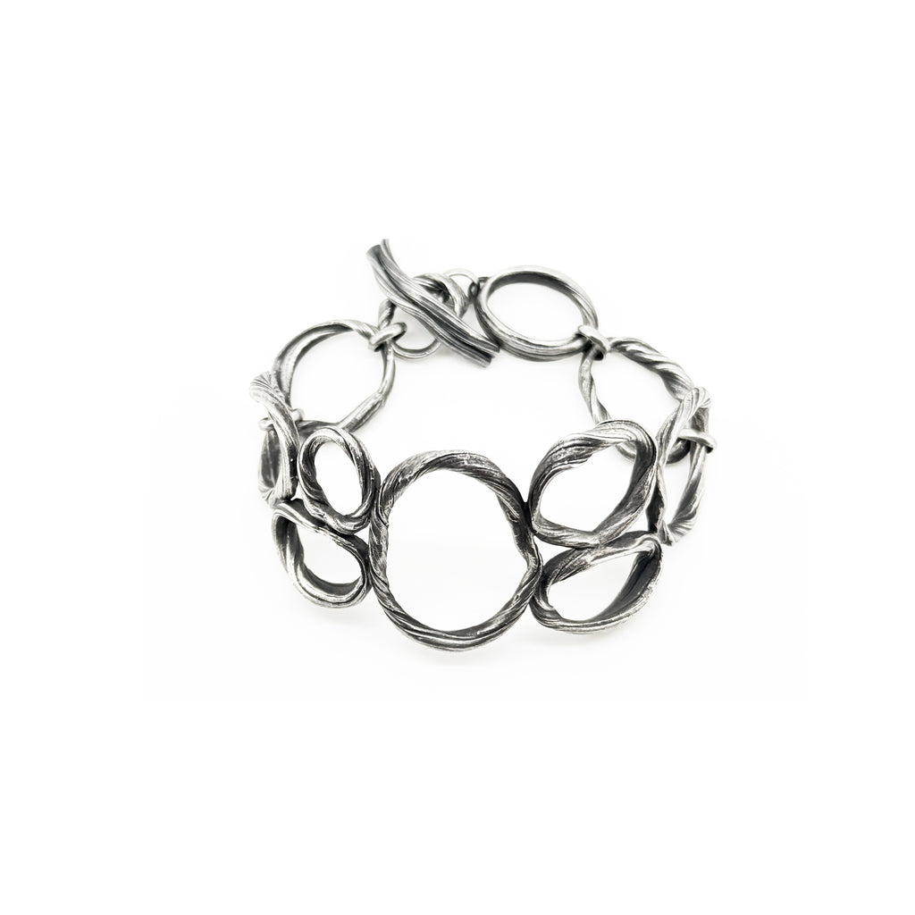 a sterling silver bracelet created to resemble beach pebbles by jewelry artist Michelle Hoting using the Mitsuro Hikime technique