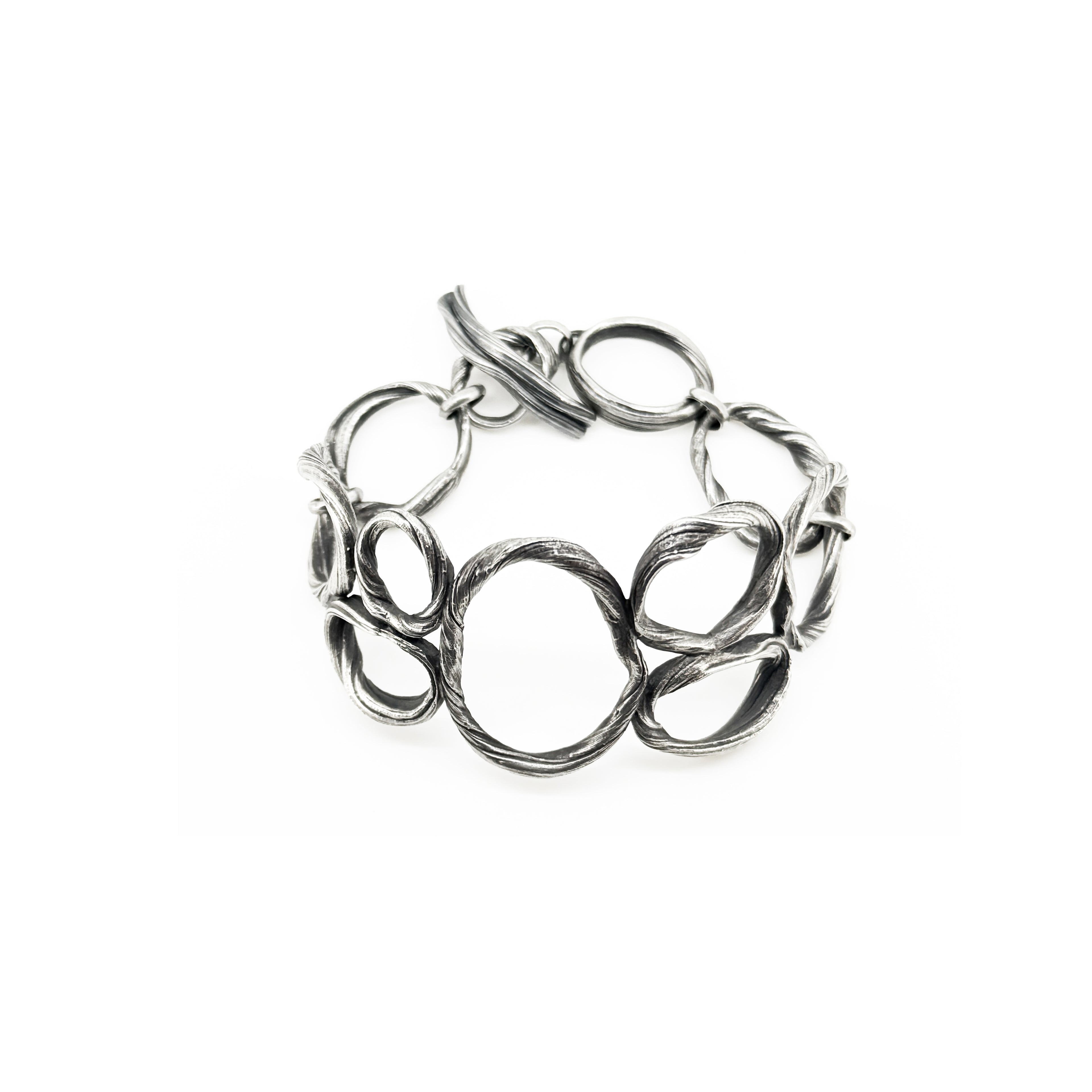 a sterling silver bracelet created to resemble beach pebbles by jewelry artist Michelle Hoting using the Mitsuro Hikime technique