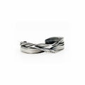 a sterling silver cuff bracelet created to resemble undulating curling waves by jewelry artist Michelle Hoting using the Mitsuro Hikime technique